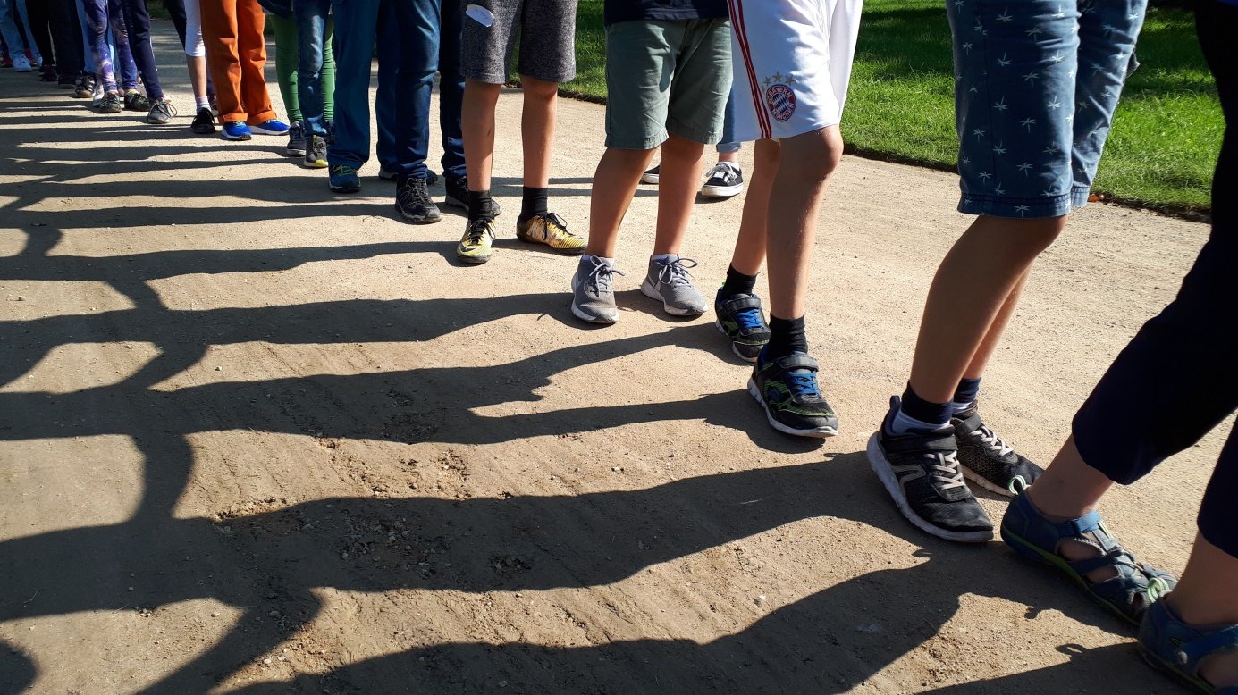 Viele Menschen in einer Reihe und ihre Schatten 