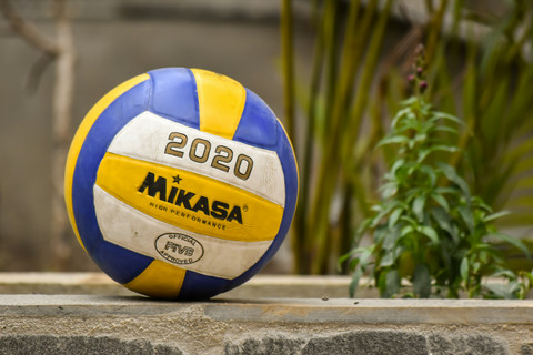 Auf einer Mauer liegt ein Volleyball.